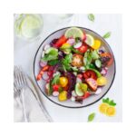 Fresh summer fruits in a bowl to avoid bloating in hot weather.