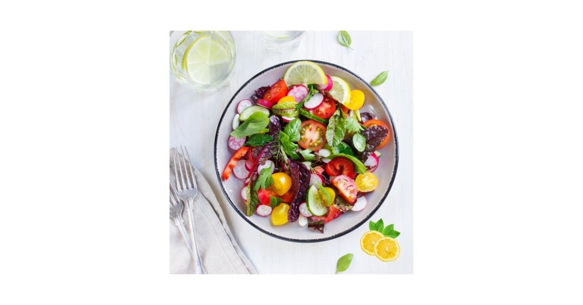 Fresh summer fruits in a bowl to avoid bloating in hot weather.