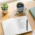 Bright flat lay of a morning desk setup with journal checklist, coffee, and sunlight representing a simple morning routine checklist with 10 easy habits for better days.
